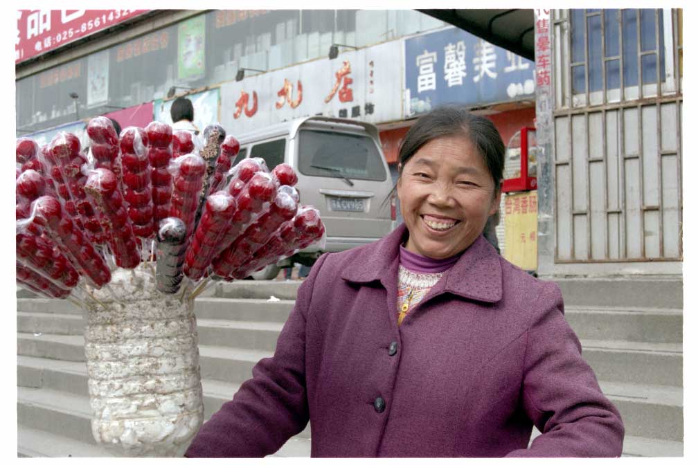 Woman selling candied chestnuts